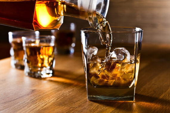 pouring whiskey over ice image